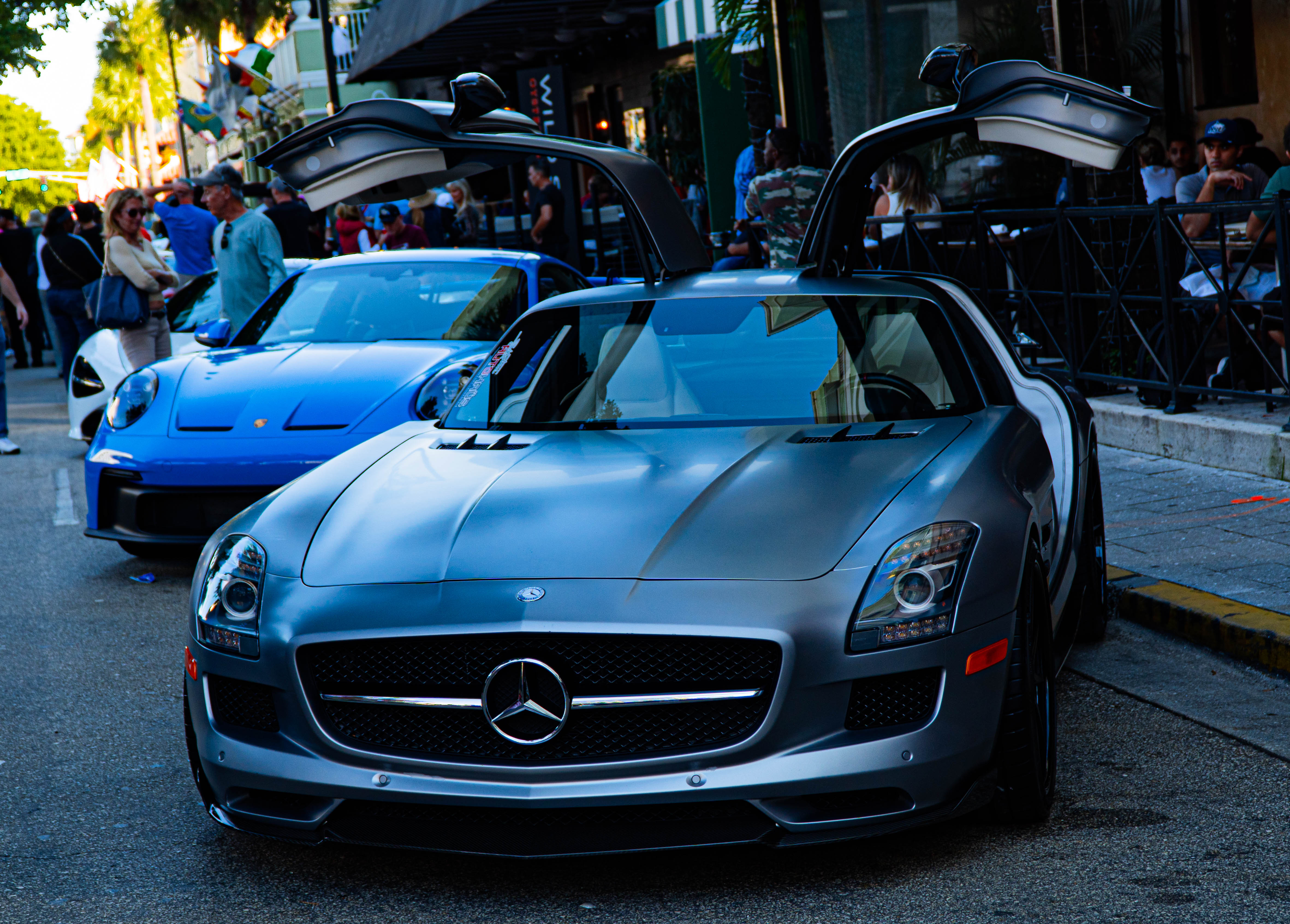 Grey Mercedes-Benz SLS AMG with gullwing doors open